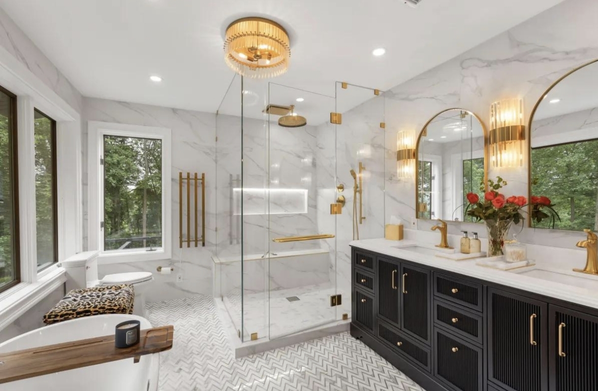 Luxury bathroom with marble walls, gold fixtures and premium vanity tile installation by KAUSH